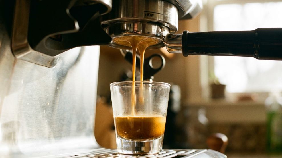 Two ristretto shots being pulled into a small glass showing short concentrated golden espresso with thick crema for Australian flat white base