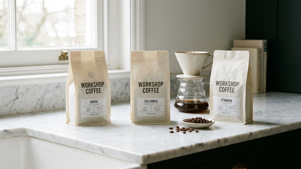 Workshop Coffee specialty bags with clean minimal branding on a white marble surface from their London Marylebone roastery