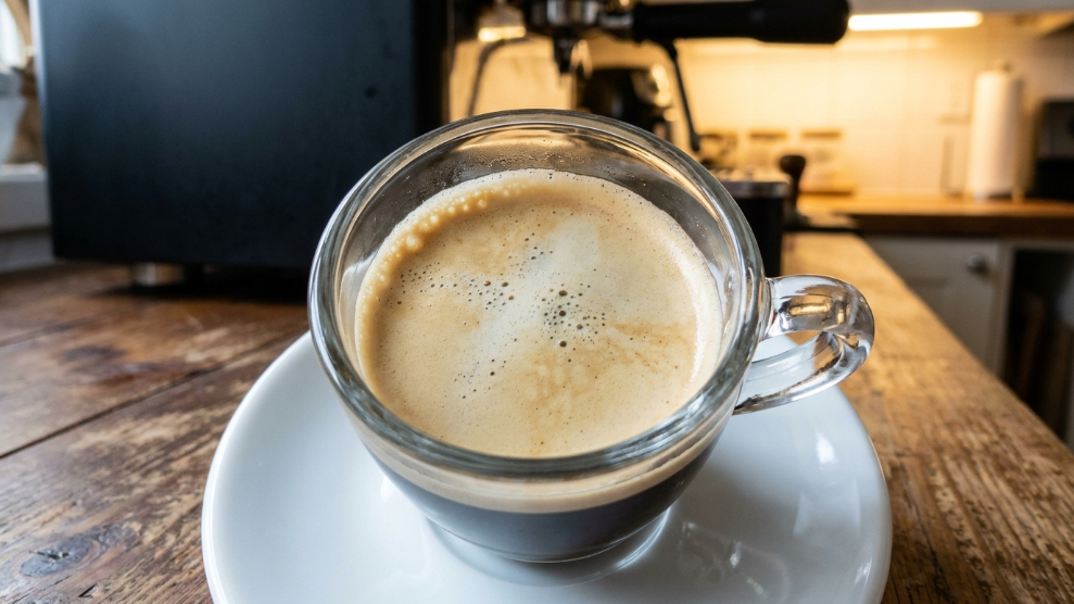 Why does my espresso tastes sour under-extracted espresso shot with thin pale crema in a glass cup.